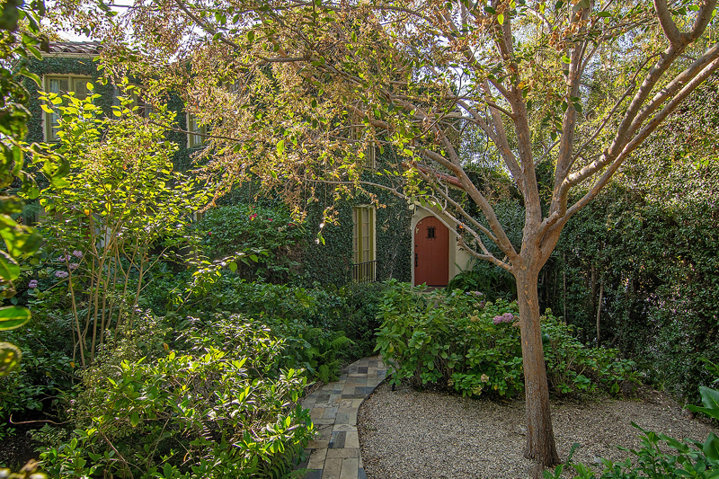 Classic 20's Hollywood Mediterranean with Enchanted Garden! Surrounded by mature hedging with Ipe decks and walkways through the lushly landscaped grounds. 3 levels, 4 bedrooms, 4 baths,  including a guest unit on separate level with a separate entrance. French doors off the living room, with a deck overlooking the spectacular private garden.